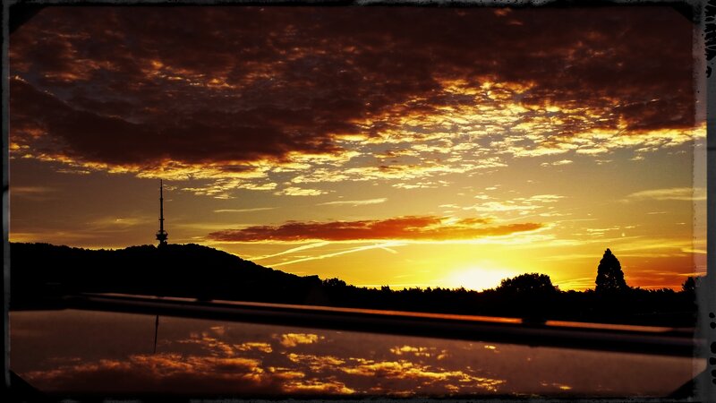 Sunset over Hill with Tower — Orange, Dramatic, Photograph, Clouds