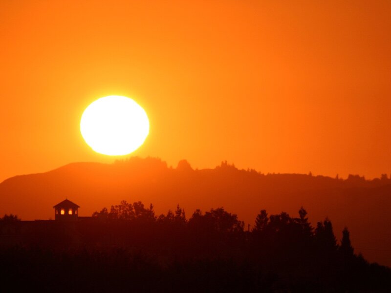 Sunset over hills and tower