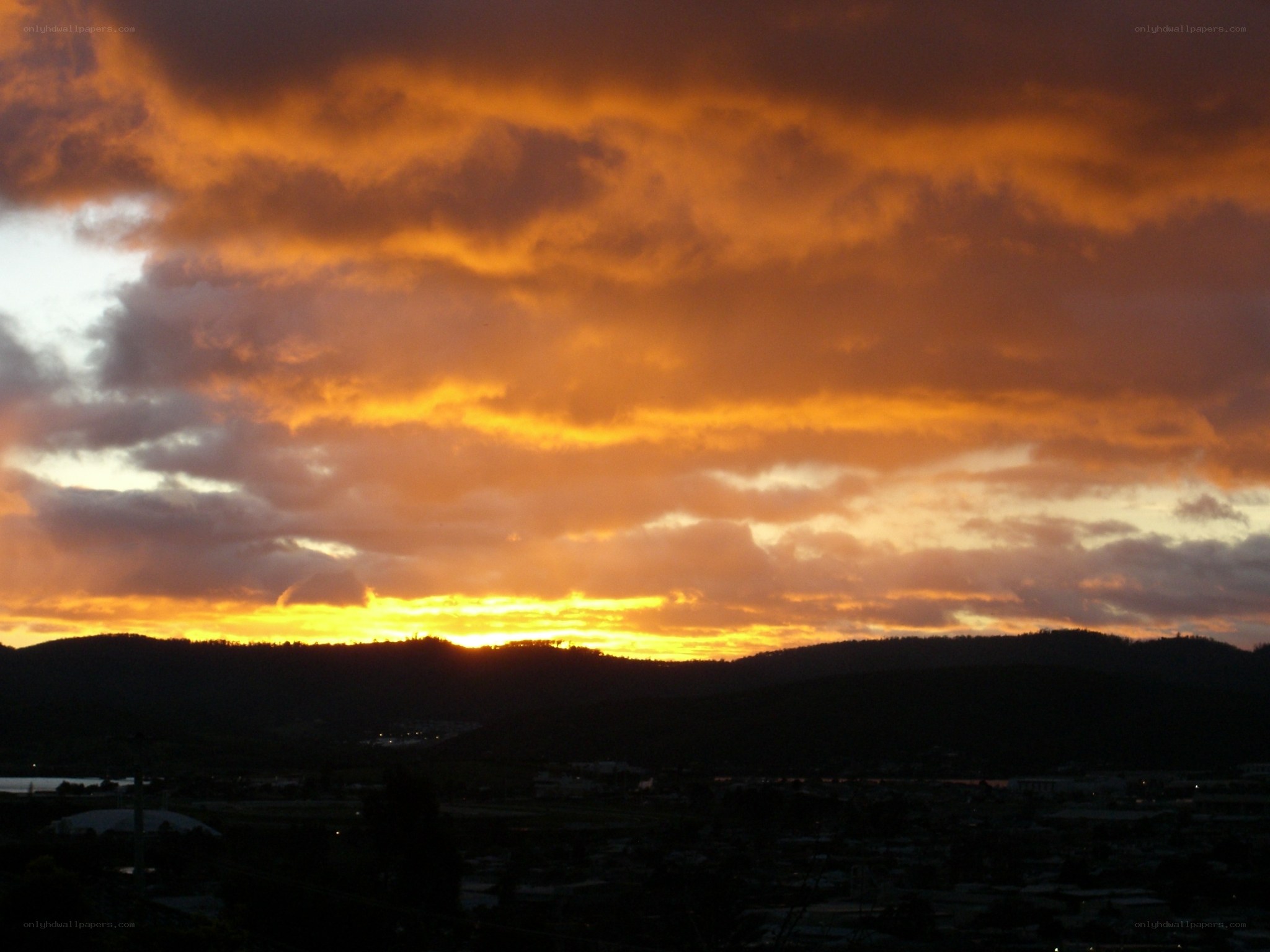 Sunset over hills and town