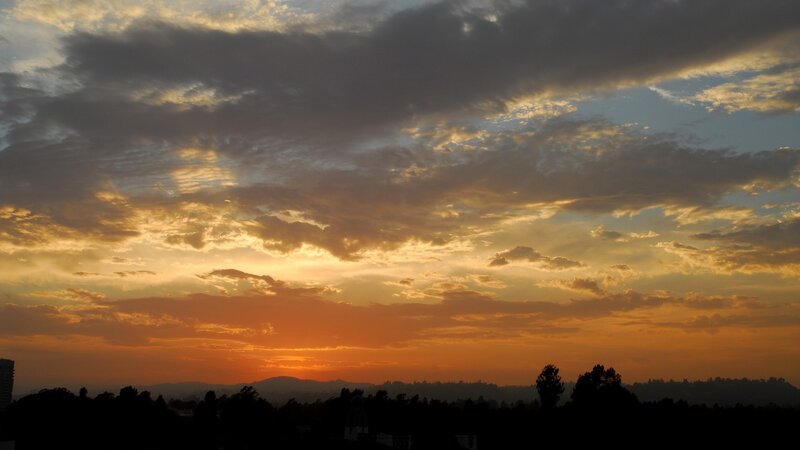 Sunset over Hills — Orange, Dramatic, Photograph, Clouds, Trees, Mountains