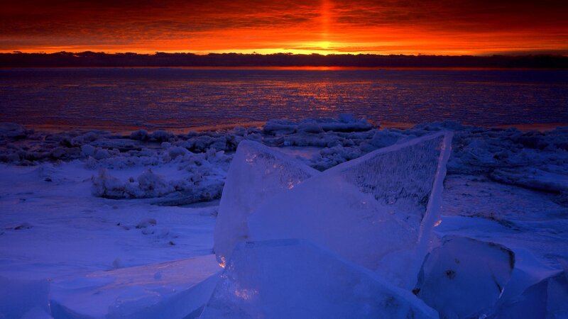 Sunset over icy shoreline