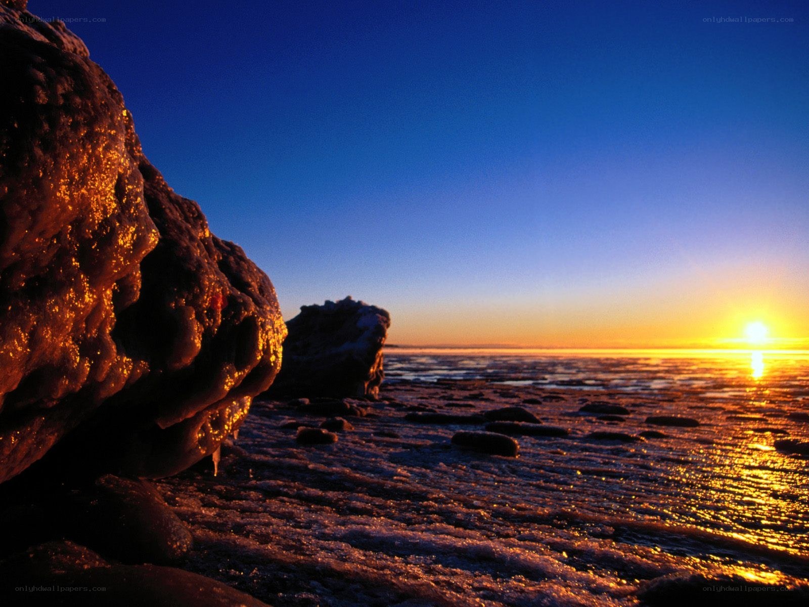 Sunset over icy shoreline
