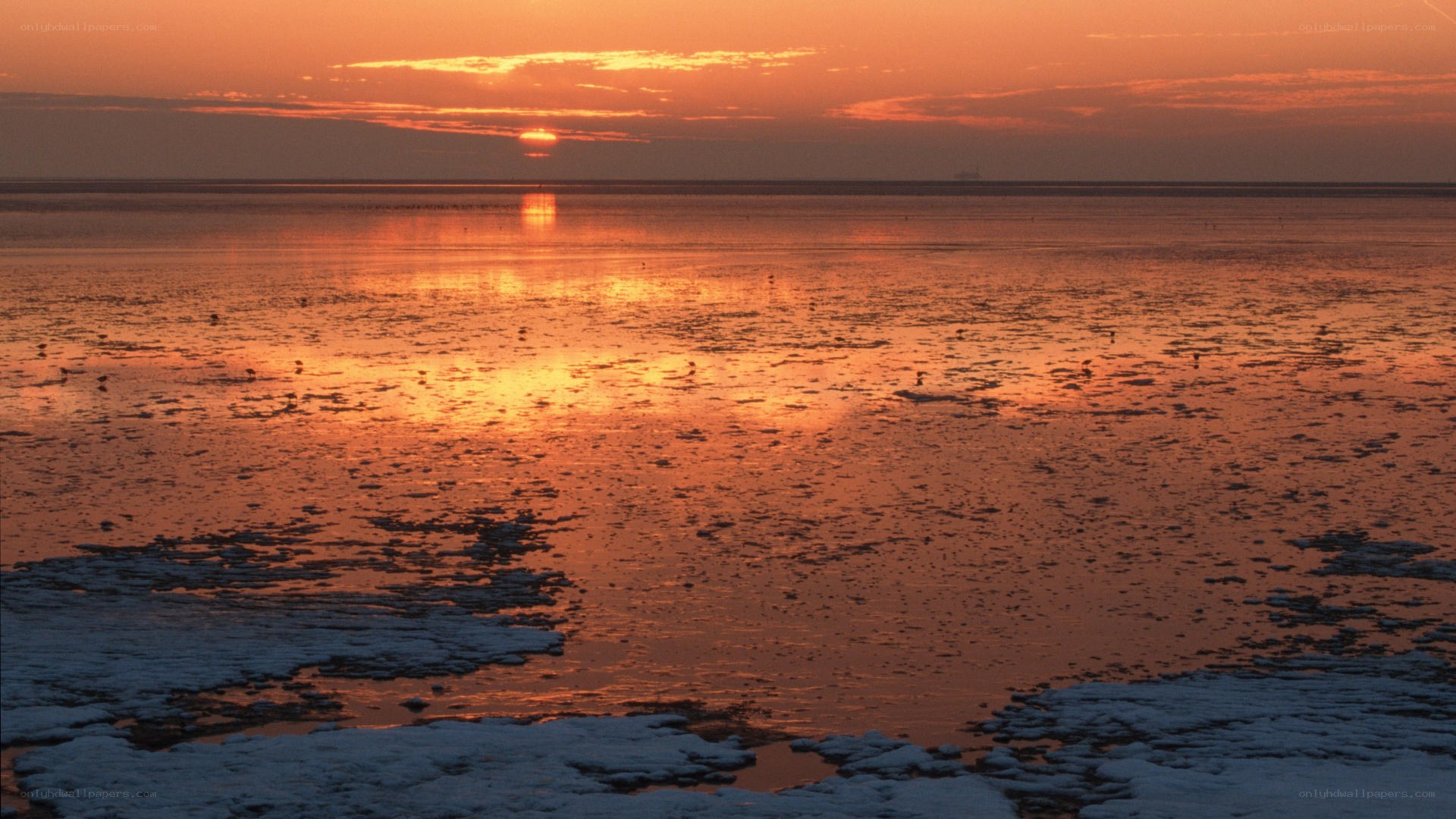 sunset over icy water