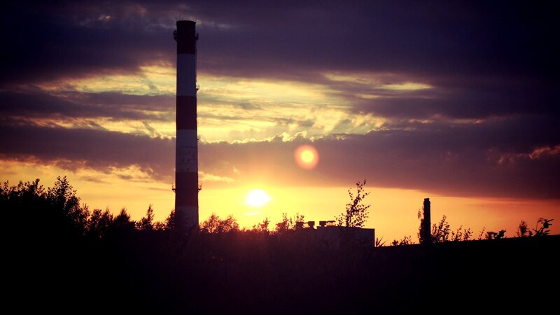 Sunset over industrial chimney