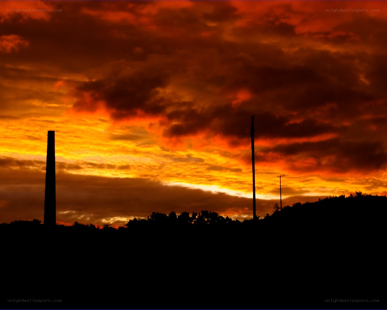sunset over industrial landscape