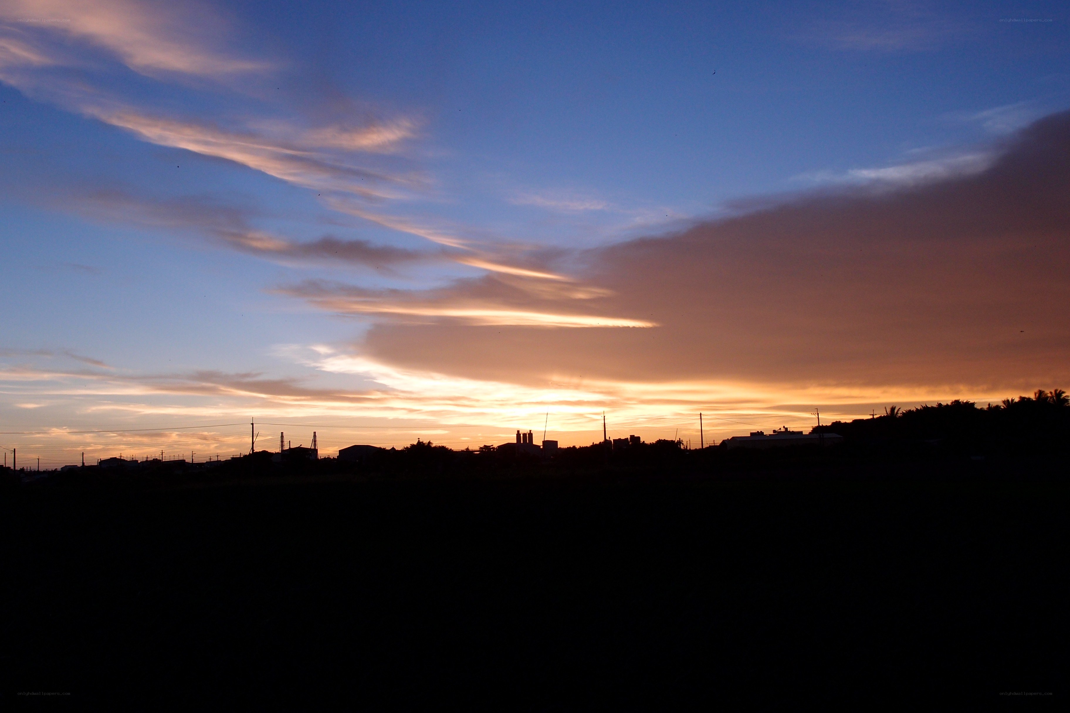 sunset over industrial landscape