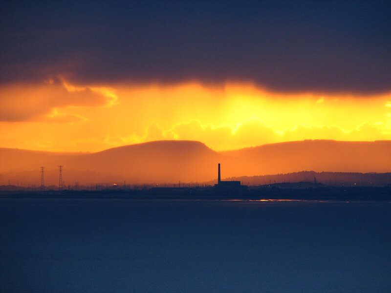 sunset over industrial landscape