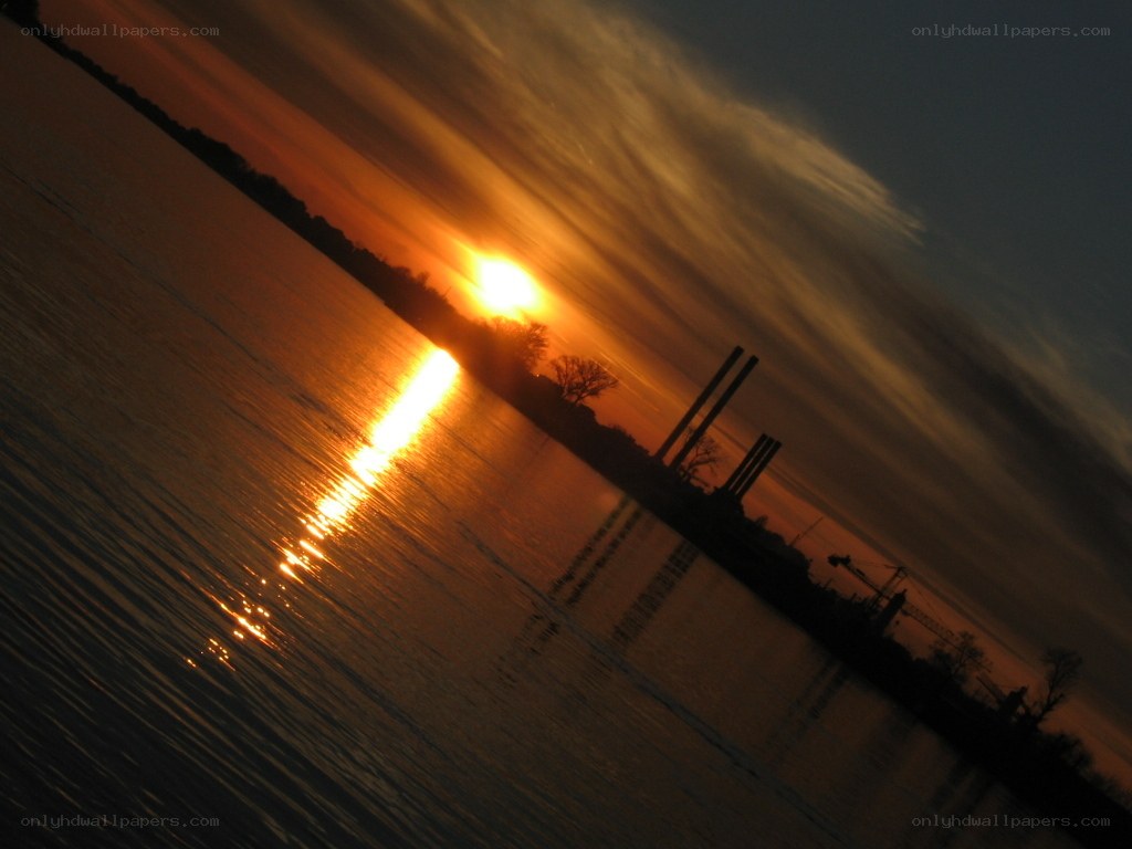 Sunset over industrial river