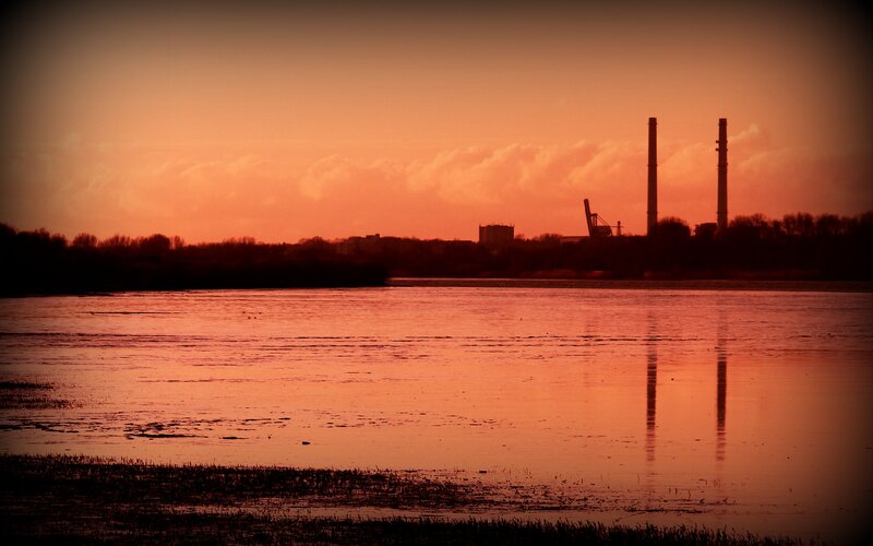 sunset over industrial river