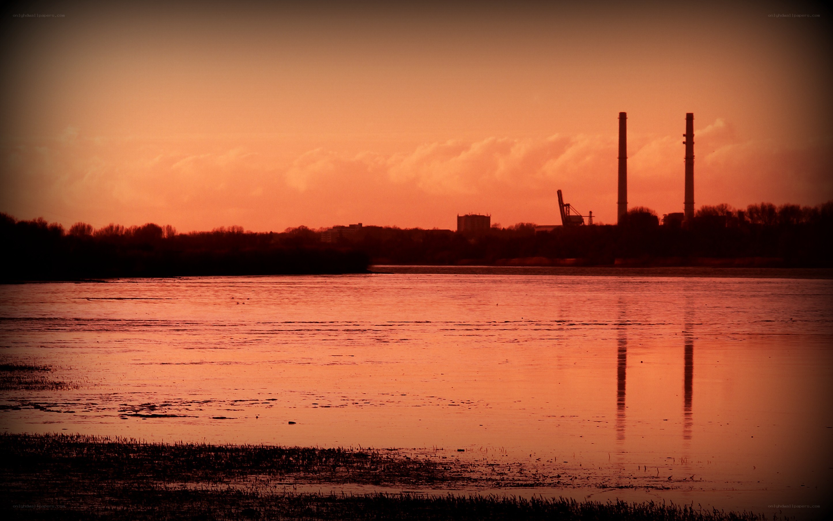 sunset over industrial river