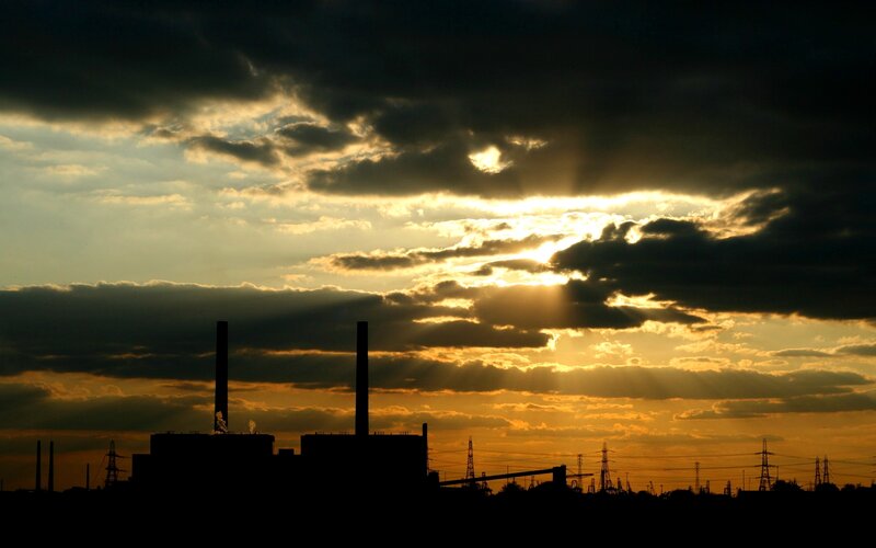 Sunset over industrial skyline