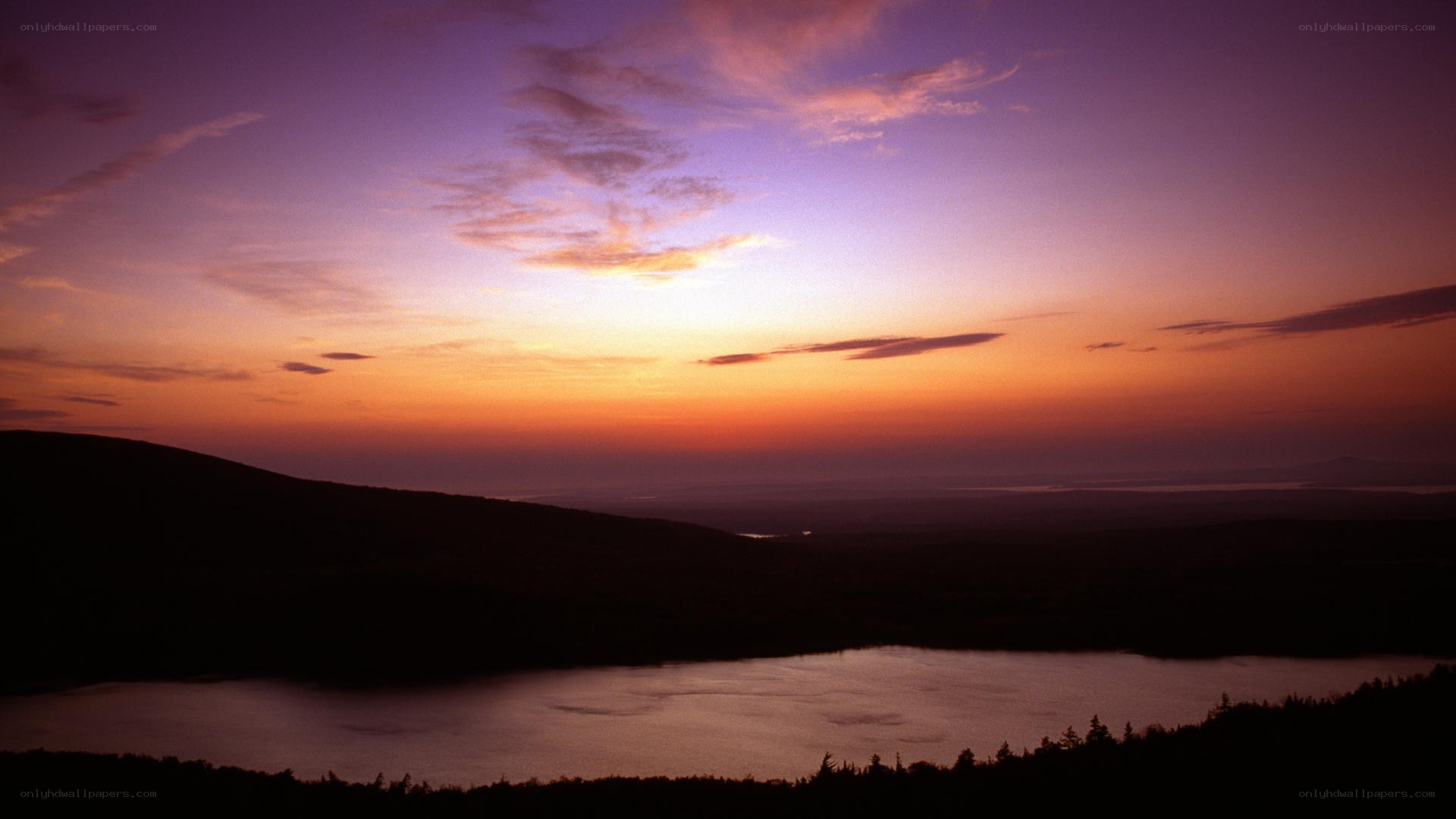 sunset over lake and hills