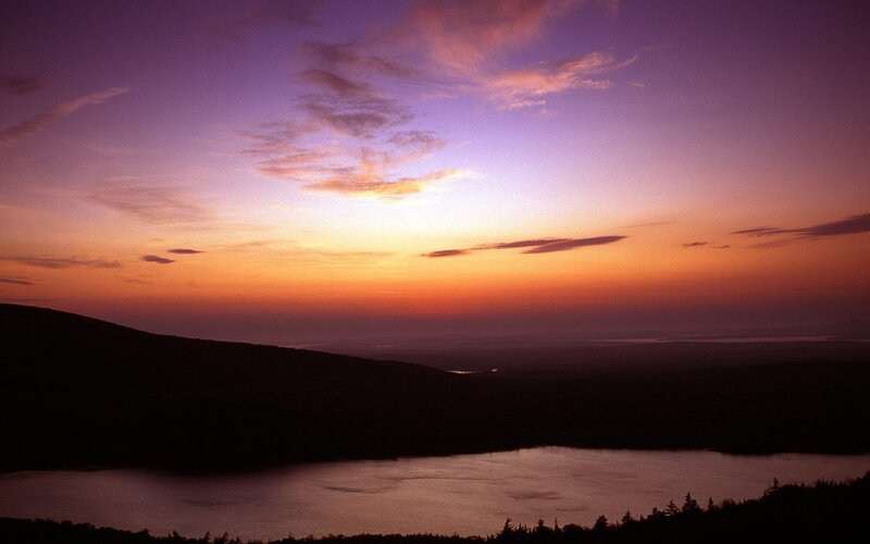 sunset over lake and hills