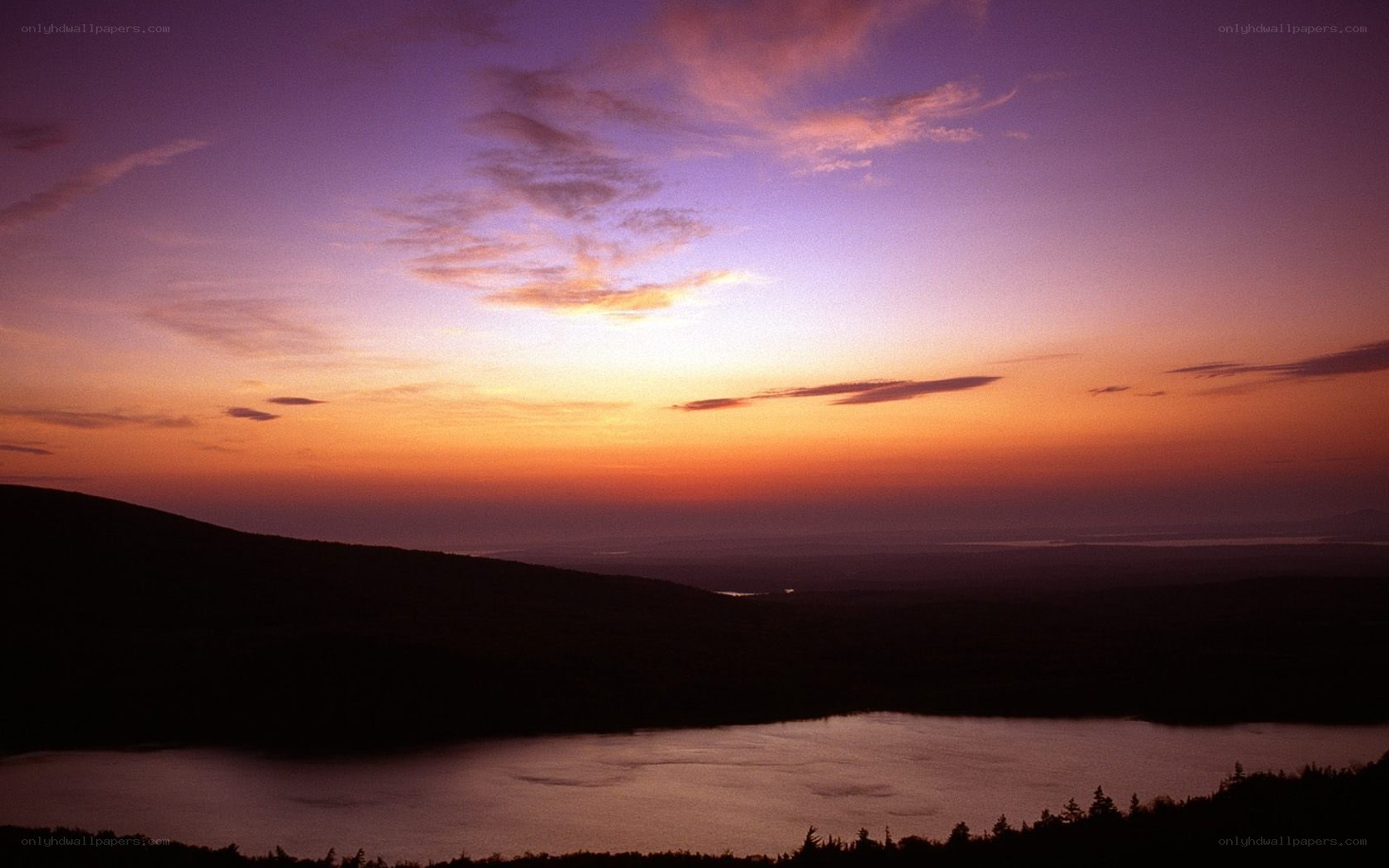 sunset over lake and hills