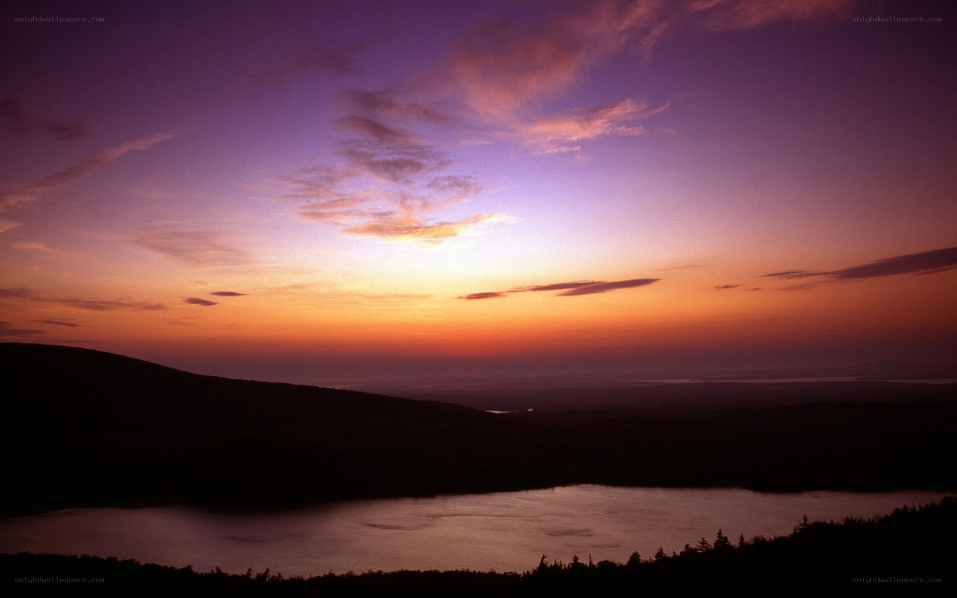 sunset over lake and hills