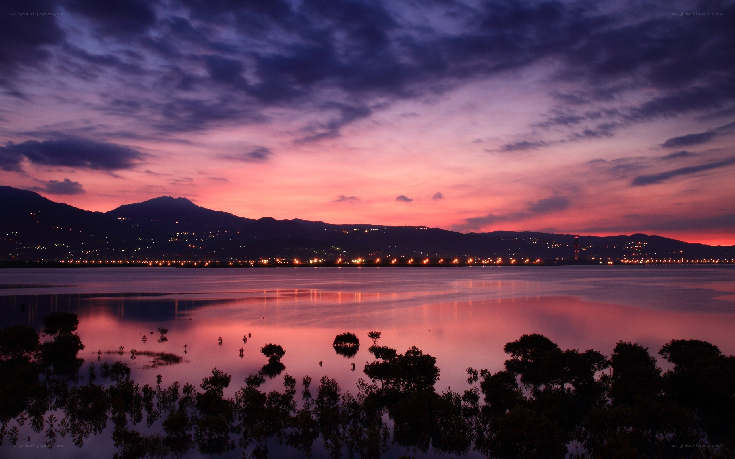 sunset over lake and mountains