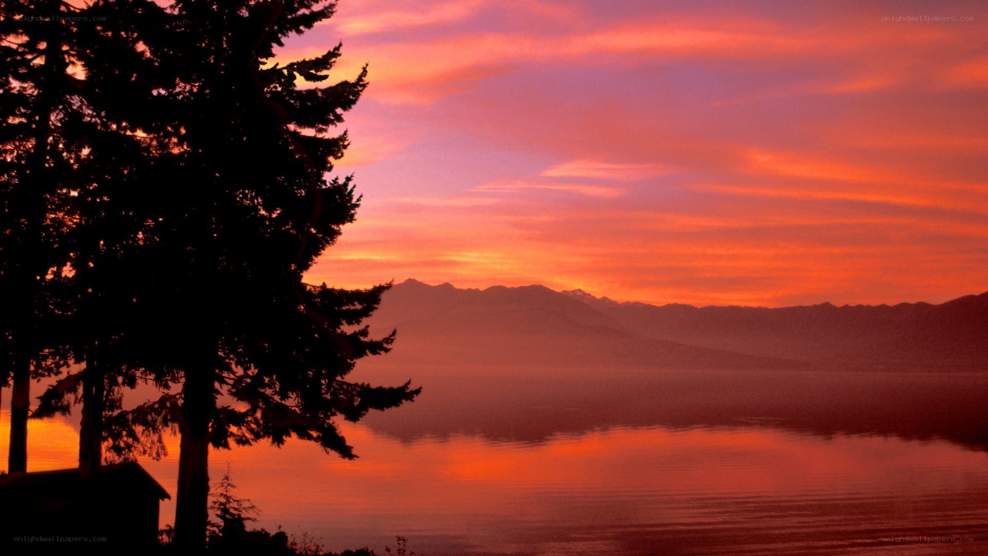 sunset over lake and mountains