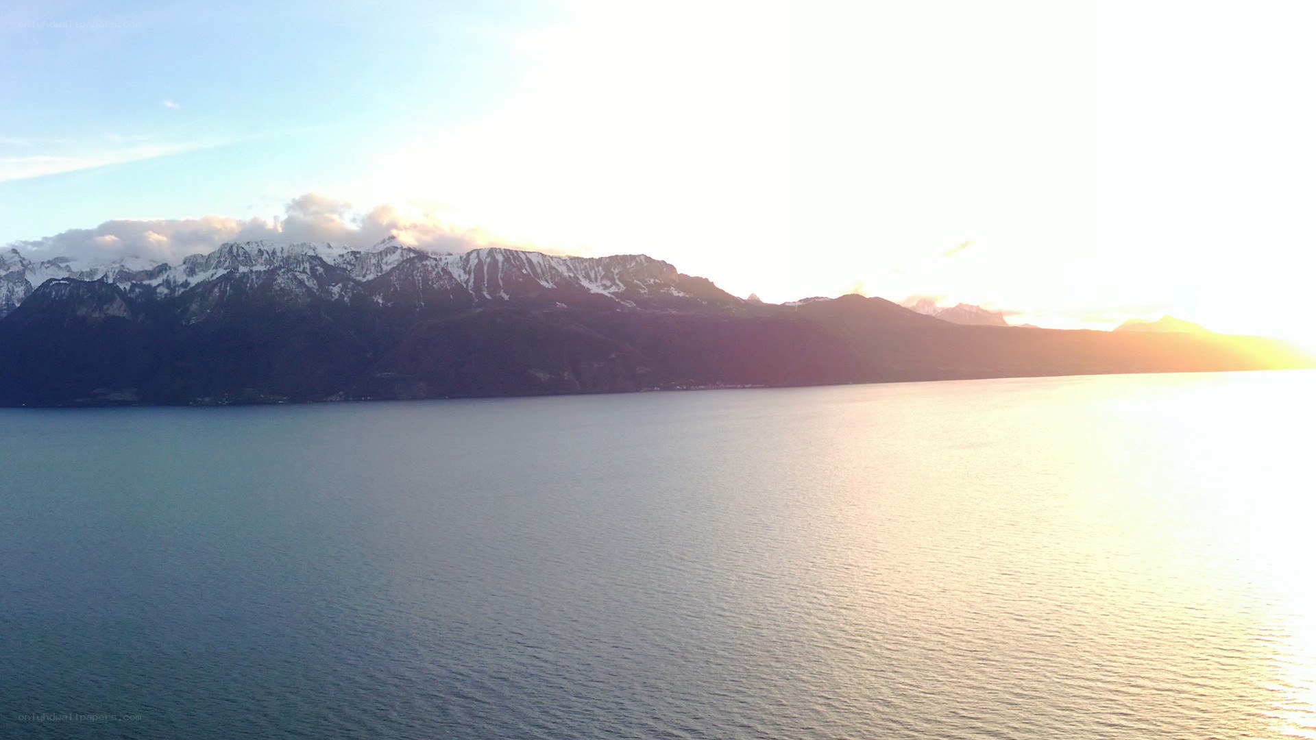 sunset over lake and mountains