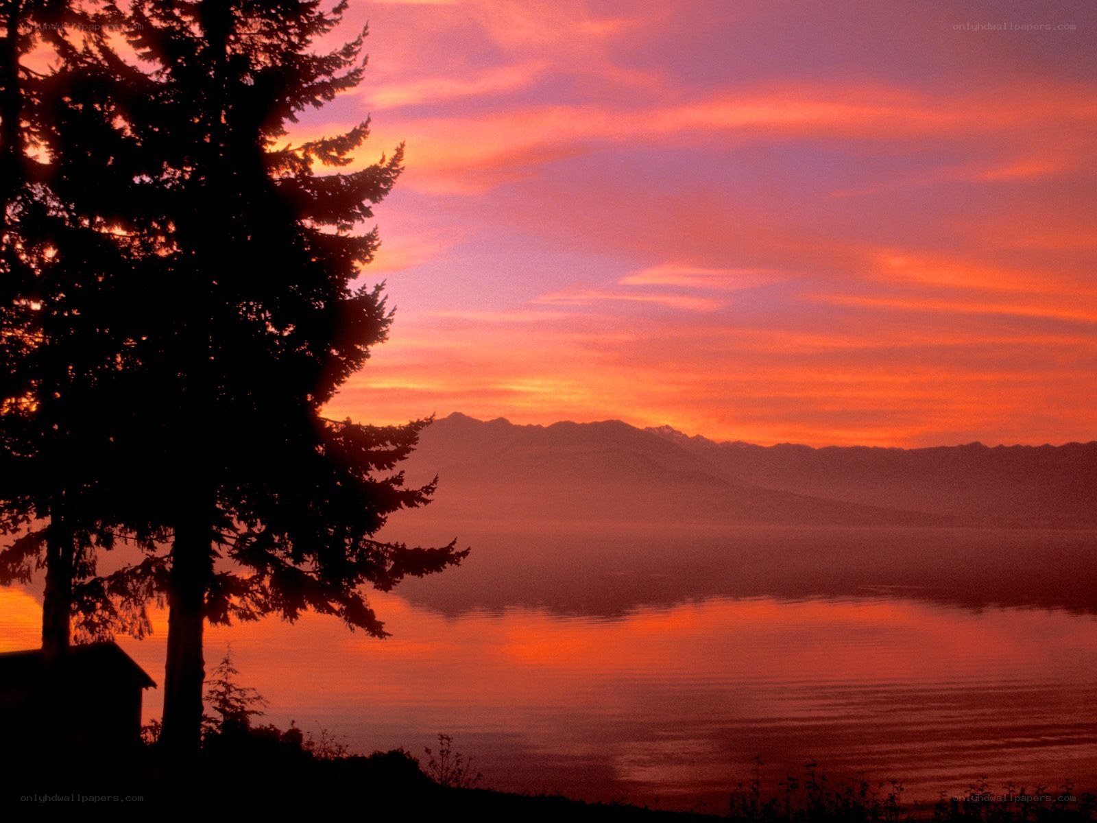 sunset over lake and mountains