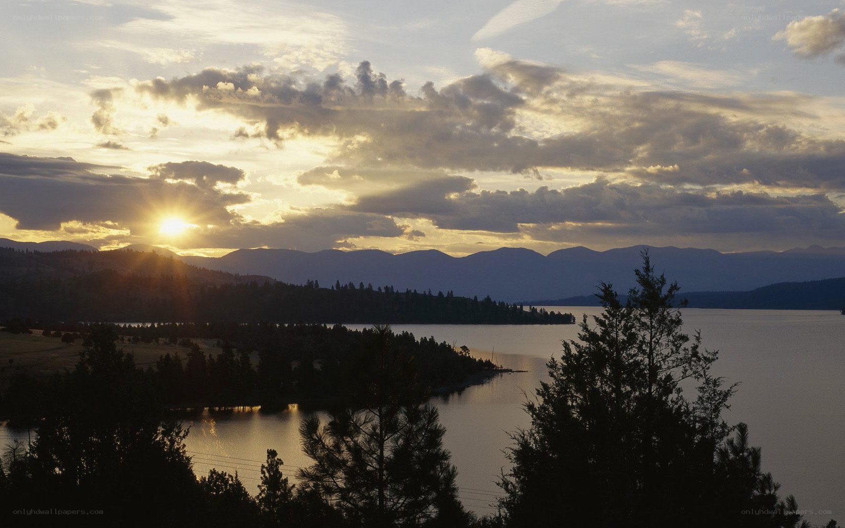 sunset over lake and mountains