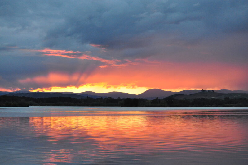 sunset over lake and mountains