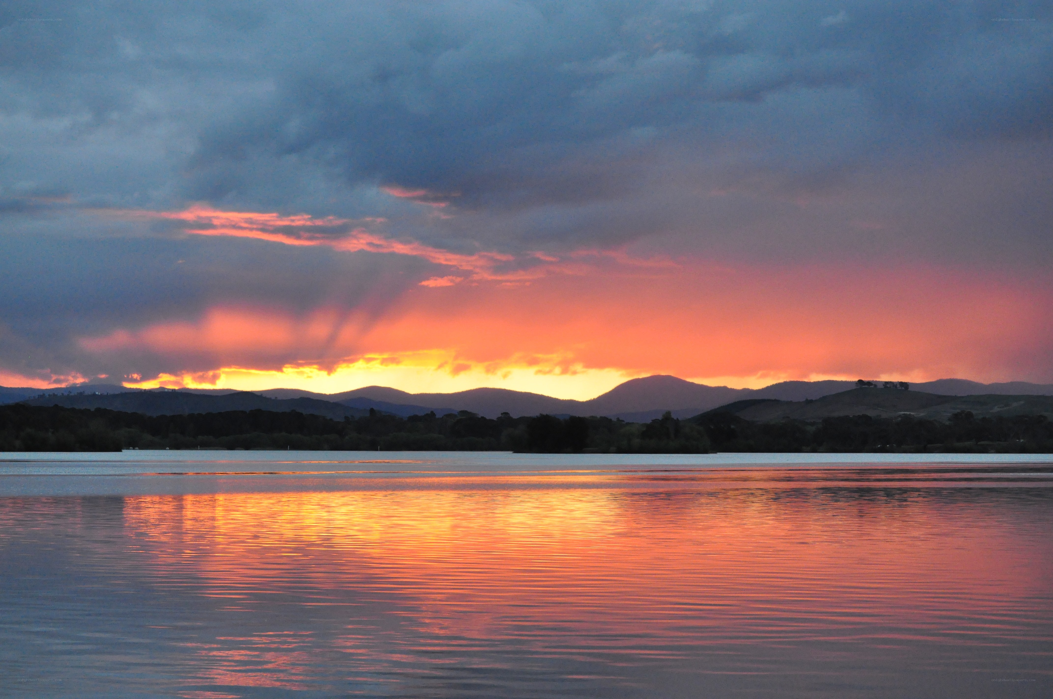 sunset over lake and mountains