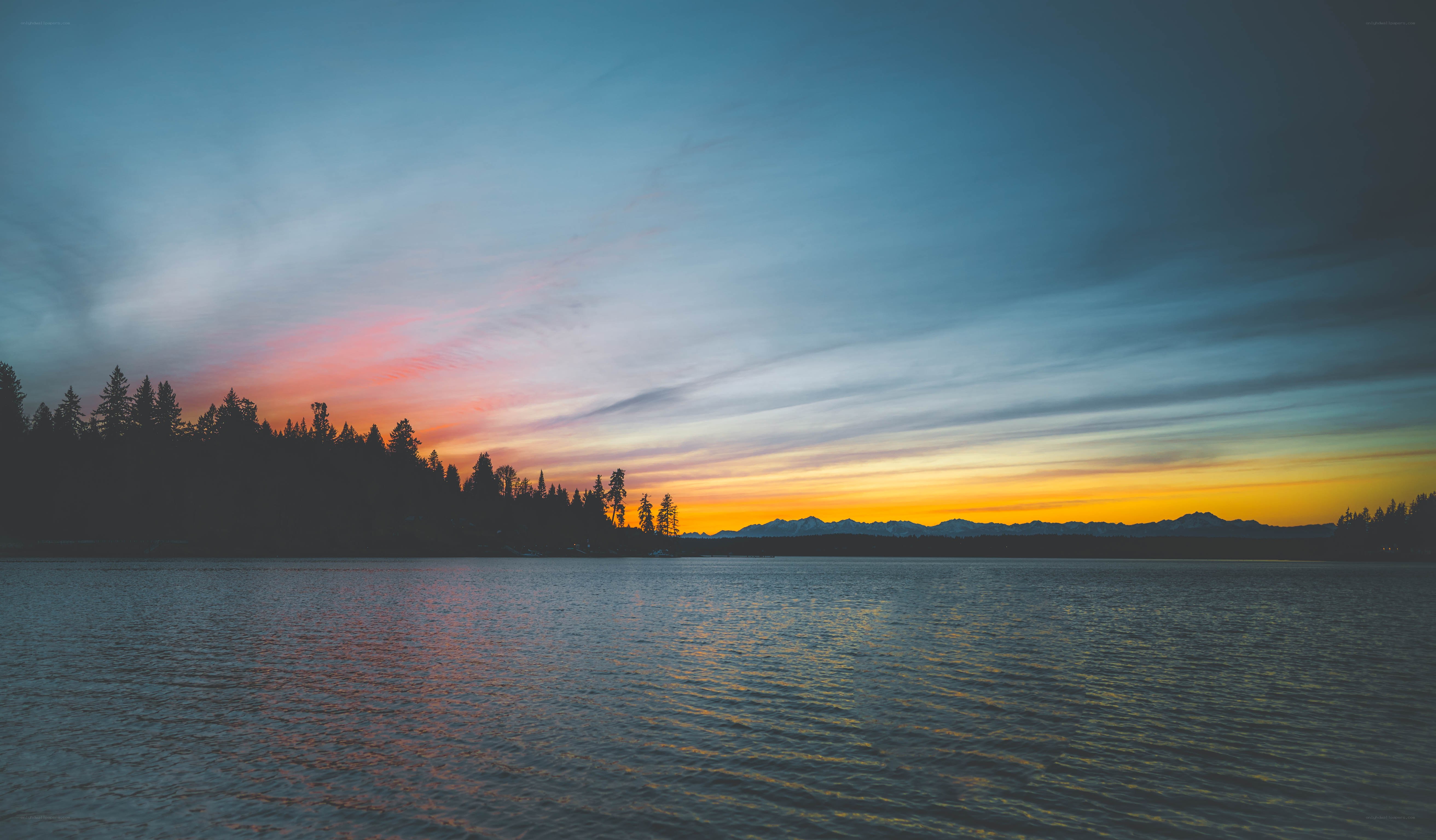 sunset over lake and mountains