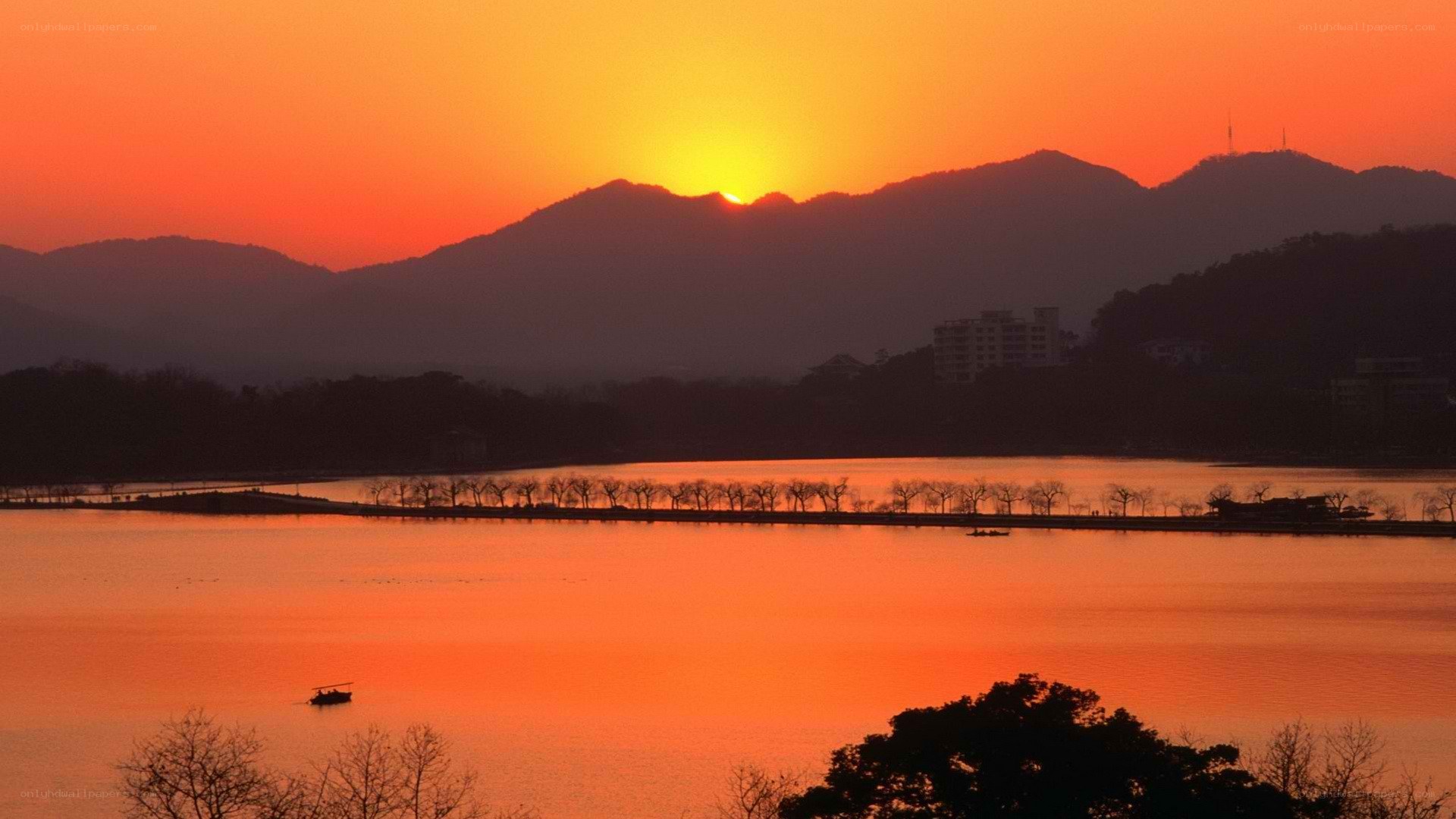 sunset over lake and mountains