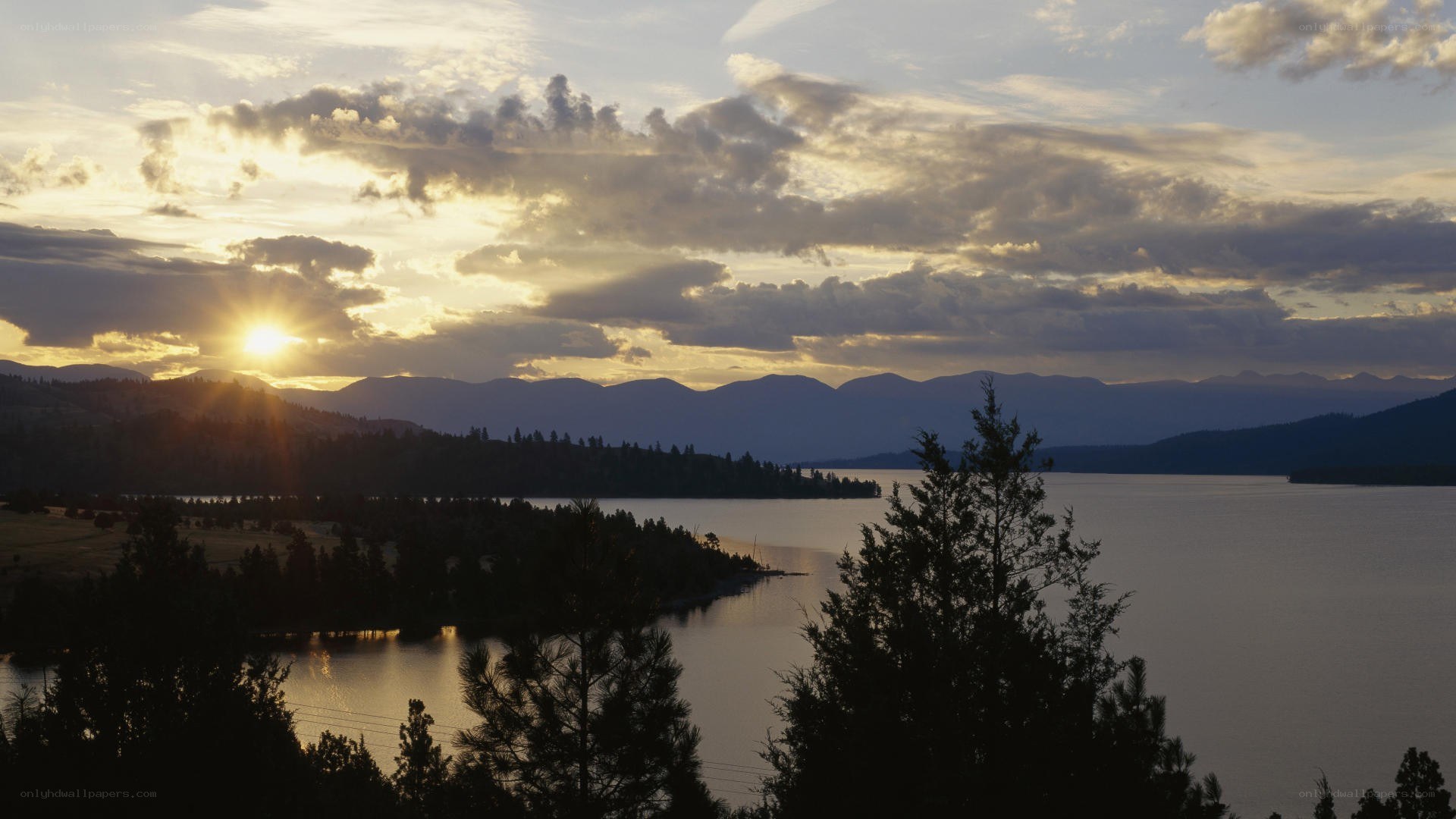 sunset over lake and mountains