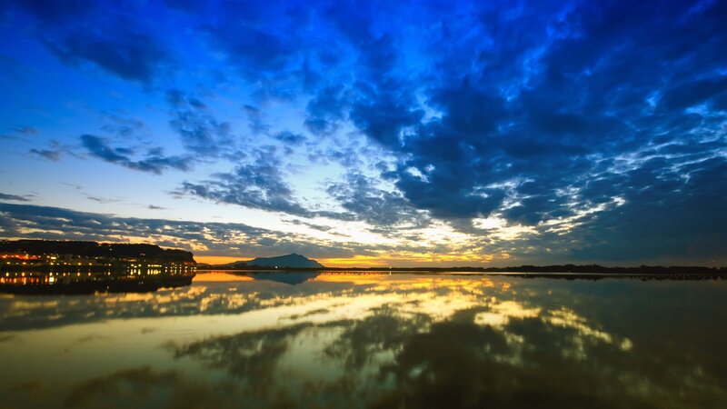 Sunset over Lake — Blue, Serene, Photograph, Clouds, Mountain, City Lights, Yellow