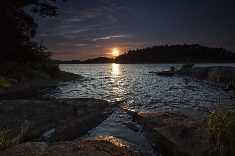 Sunset over Lake — Blue, Serene, Photograph, Rocks, Trees