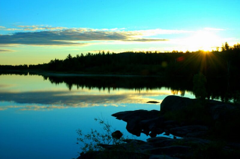 Sunset over Lake — Blue, Serene, Photograph, Sun, Trees, Rocks