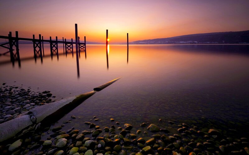 Sunset over Lake — Orange, Serene, Photograph, Dock, Pebbles