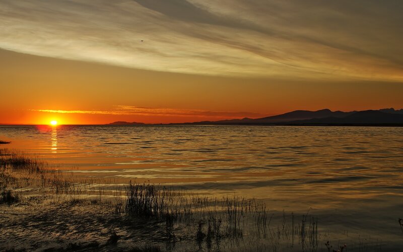 Sunset over Lake — Orange, Serene, Photograph, Mountains, Sky, Water, Reeds, Yellow