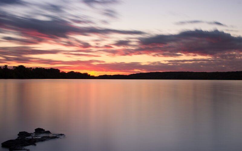 Sunset over Lake — Orange, Serene, Photograph, Sky, Clouds, Trees, Rocks