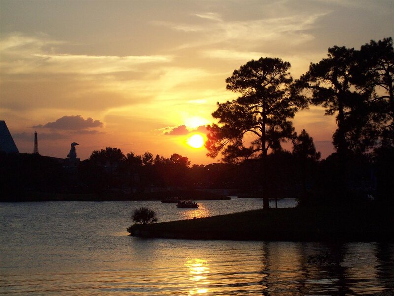Sunset over Lake — Orange, Serene, Photograph, Trees, Boat, Statue