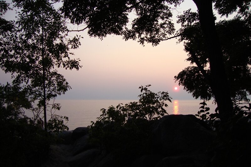 Sunset over Lake — Pink, Serene, Photograph, Trees, Rocks