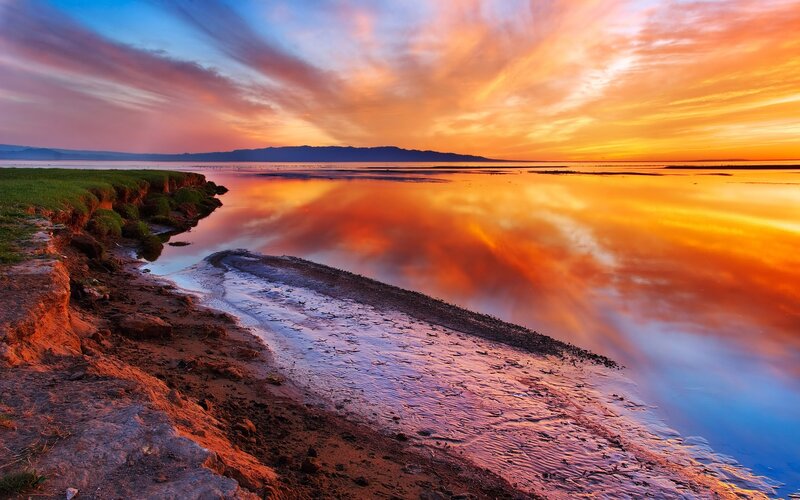 Sunset over Lake Shore — Orange, Dramatic, Photograph, Sky, Water, Mountains