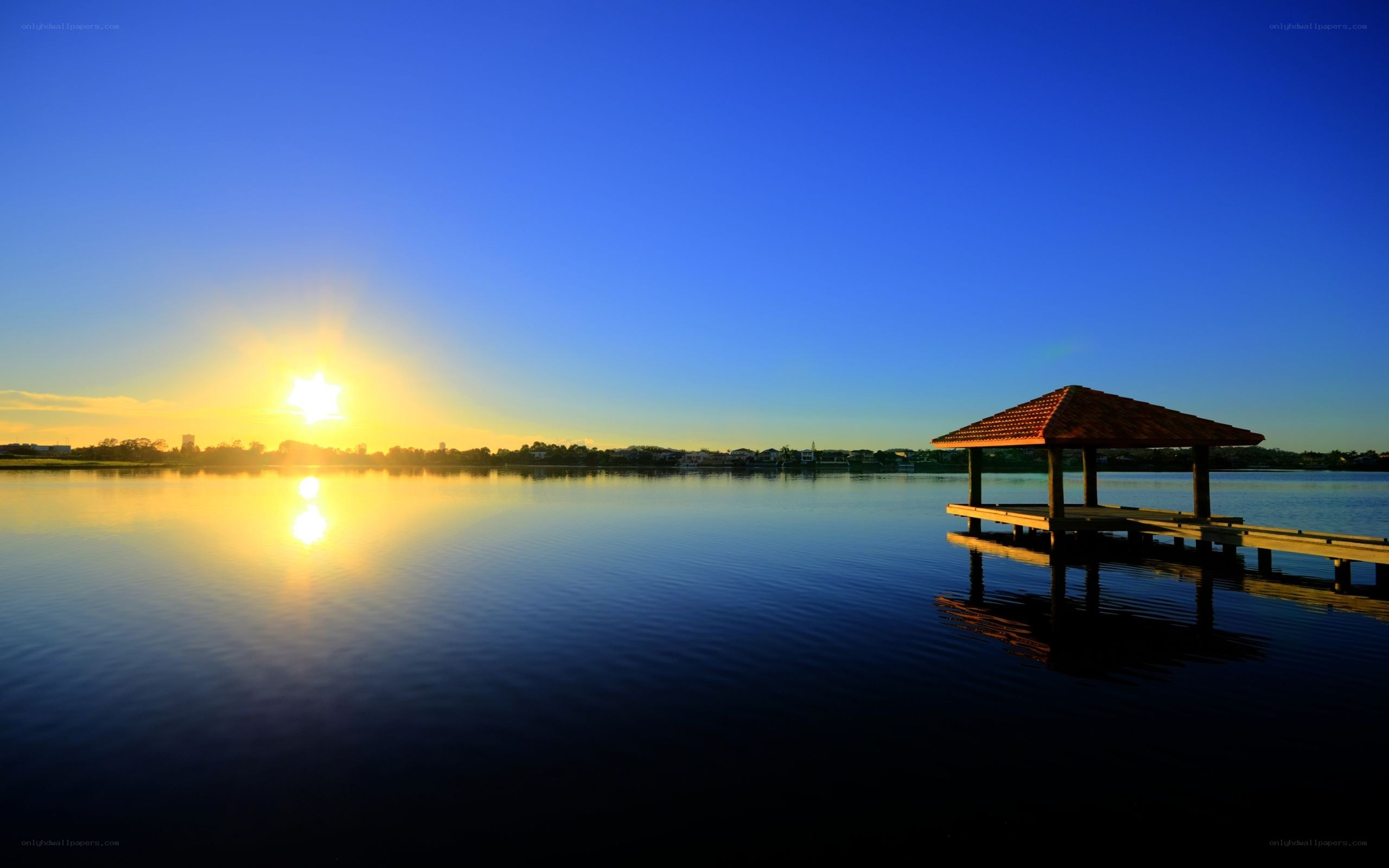 Sunset over lake with gazebo