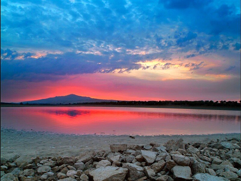 sunset over lake with mountain