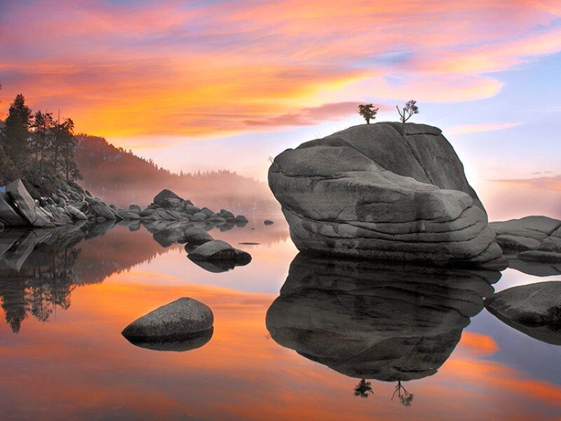 Sunset over lake with rock formation