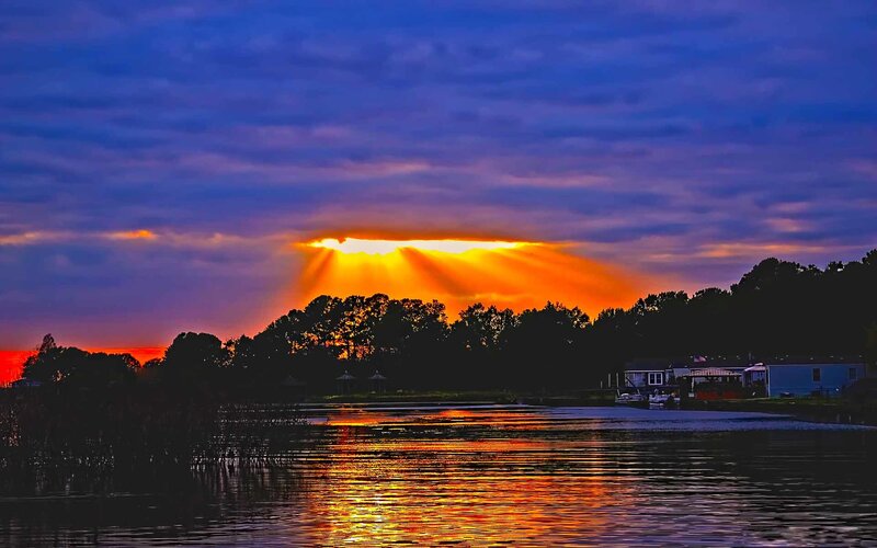 sunset over lake with sunbeams