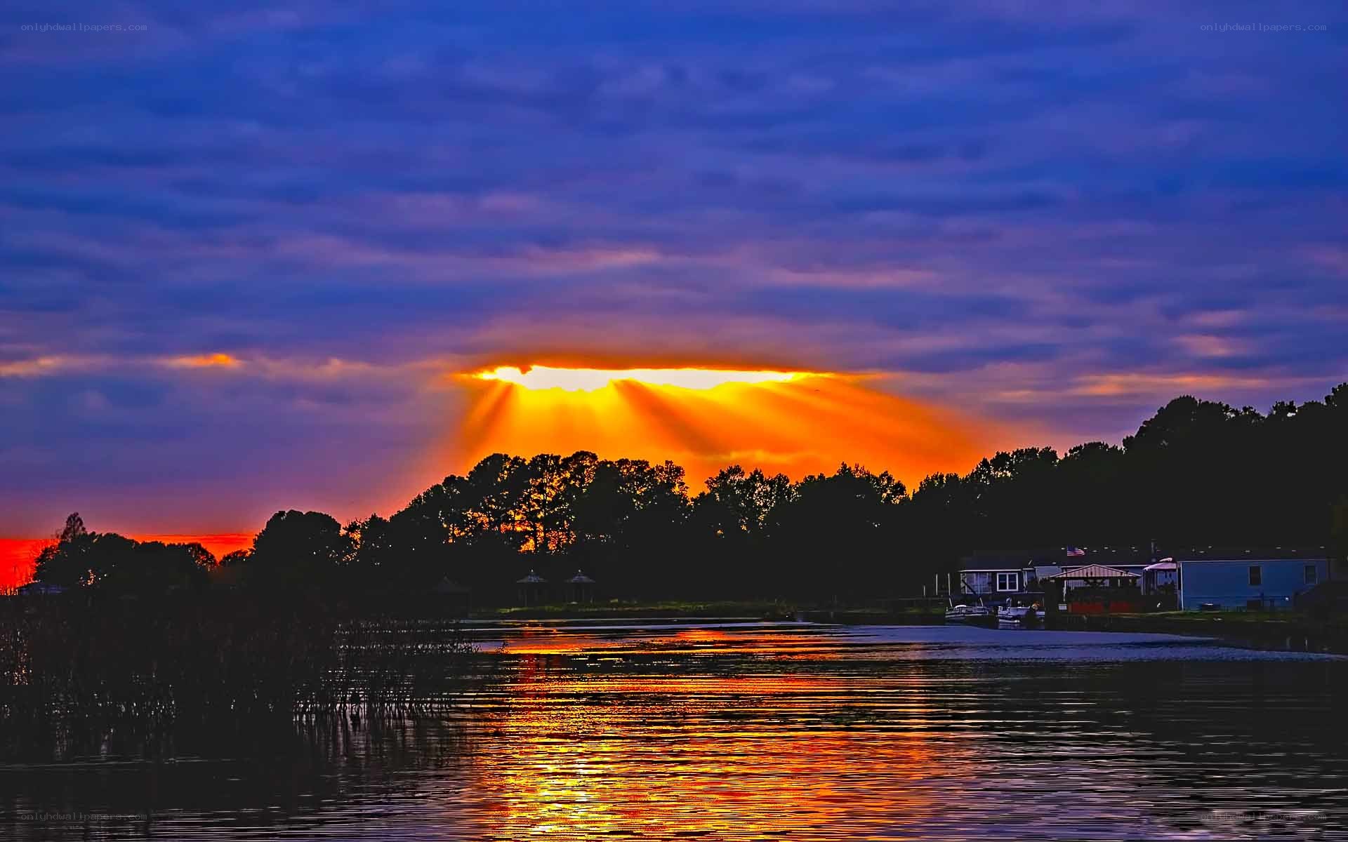 sunset over lake with sunbeams