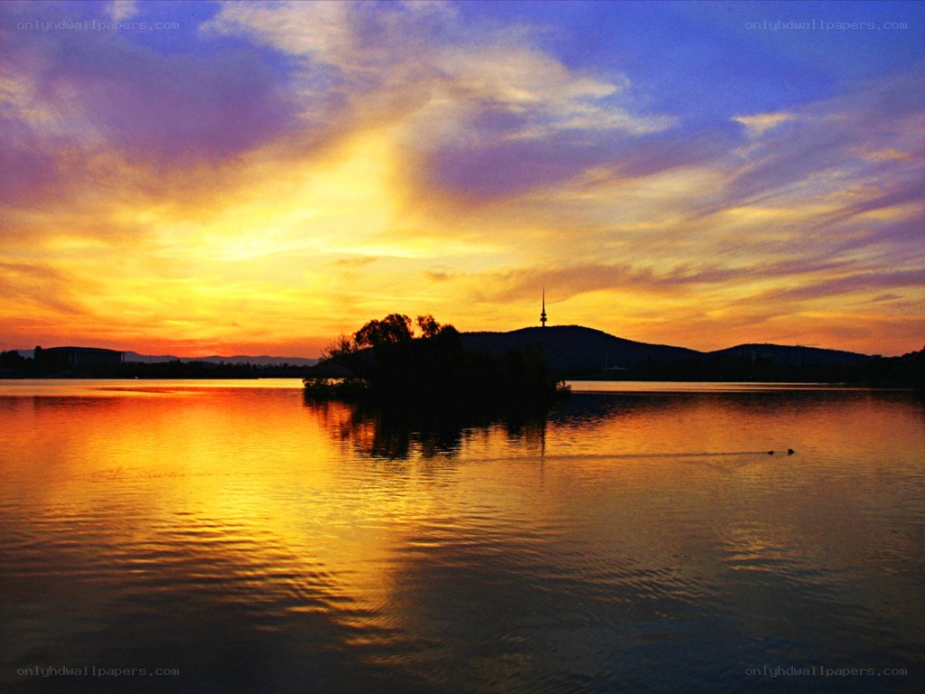 sunset over lake with tower