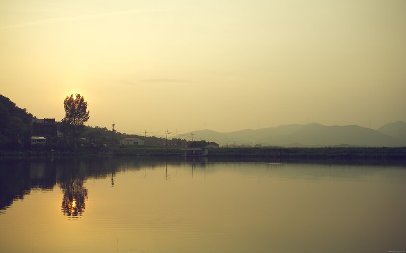 Sunset over Lake — Yellow, Serene, Photograph, Trees, Houses, Mountains