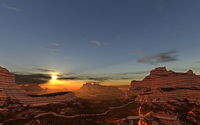 Sunset over layered rock formations