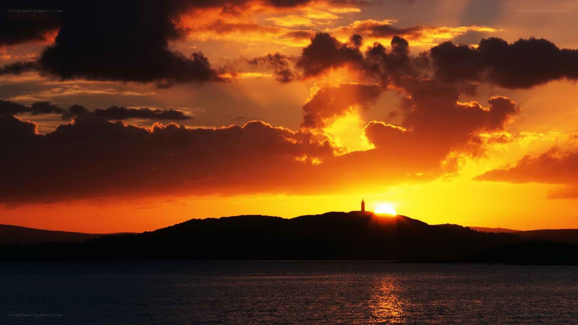 Sunset over lighthouse silhouette
