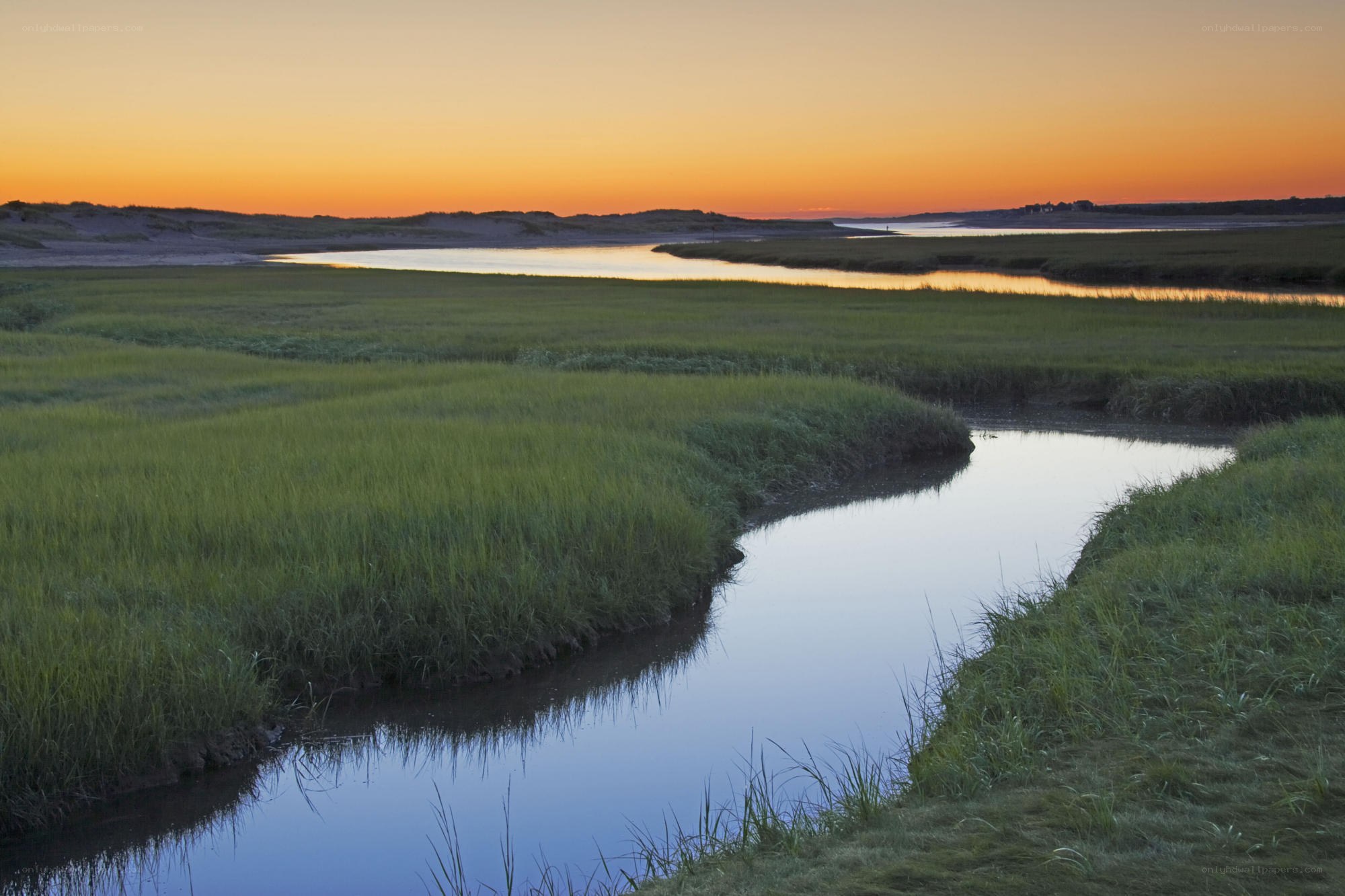 Sunset over marshland stream