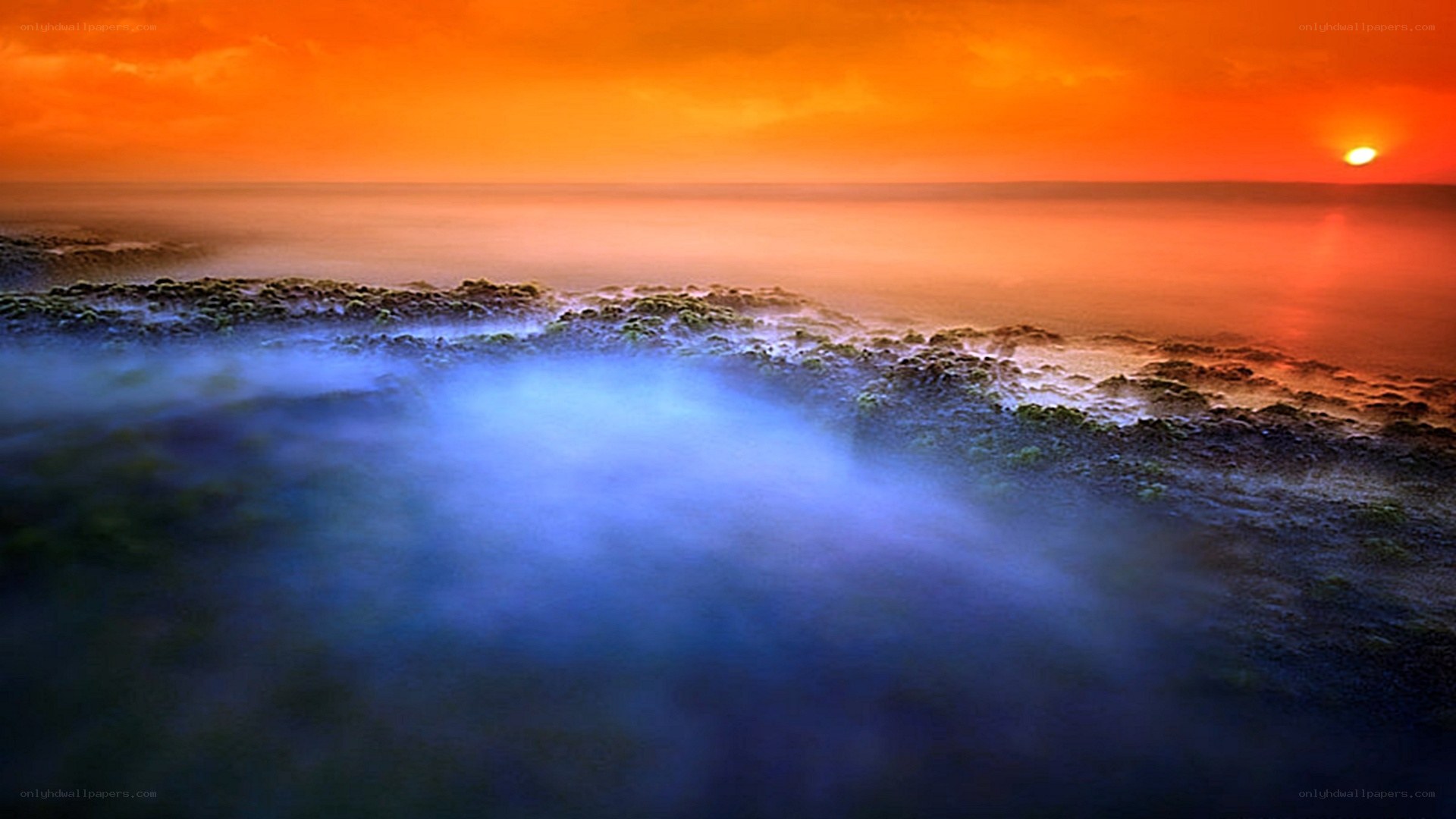 Sunset over misty coastline