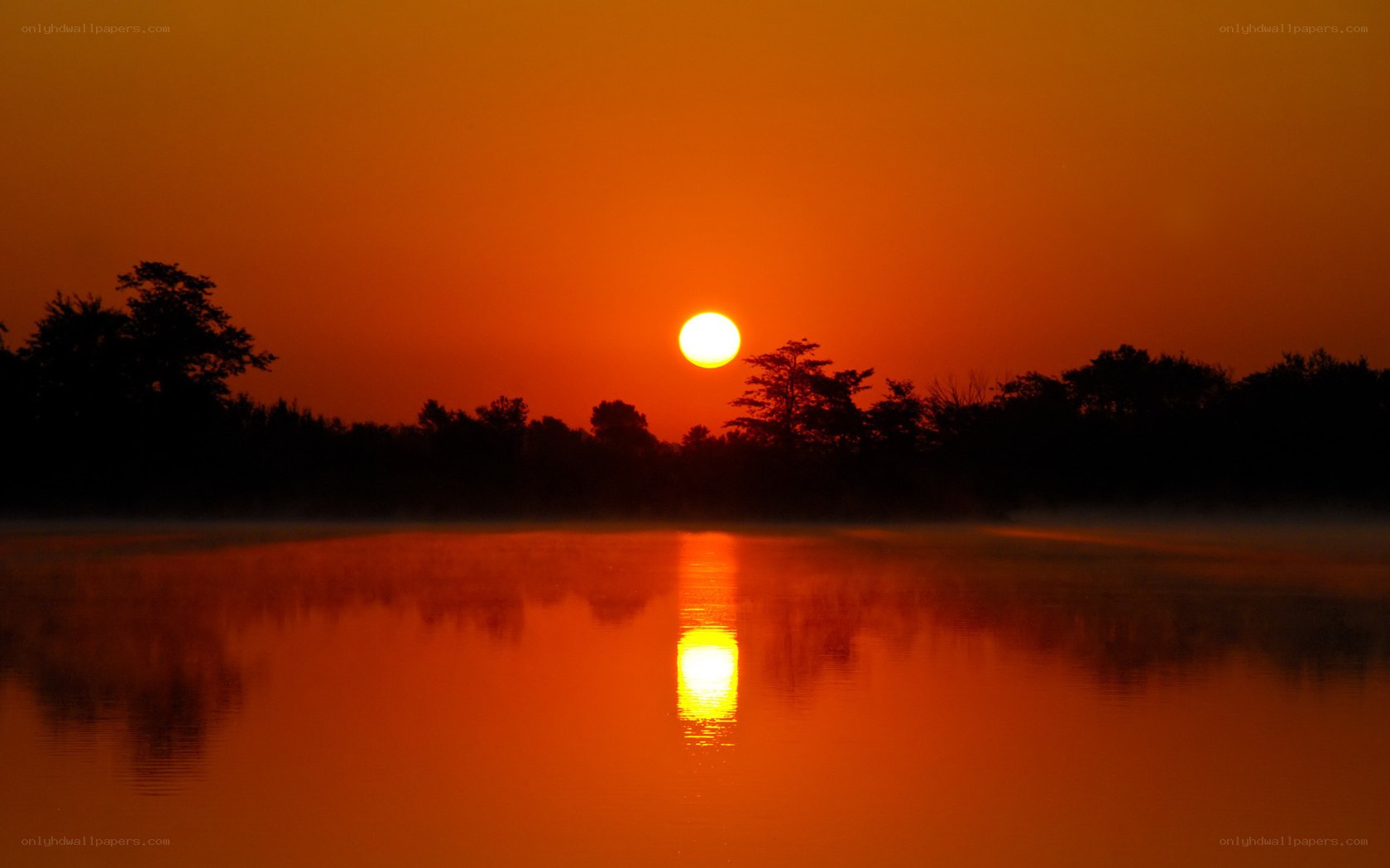 Sunset over misty lake